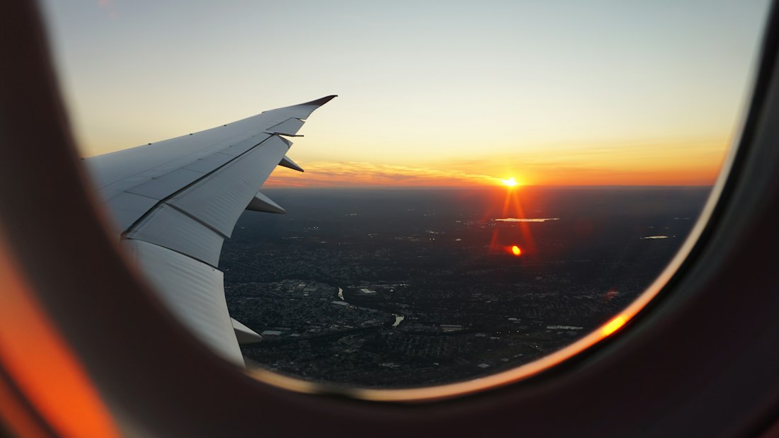 The view from a plane window at sunset
