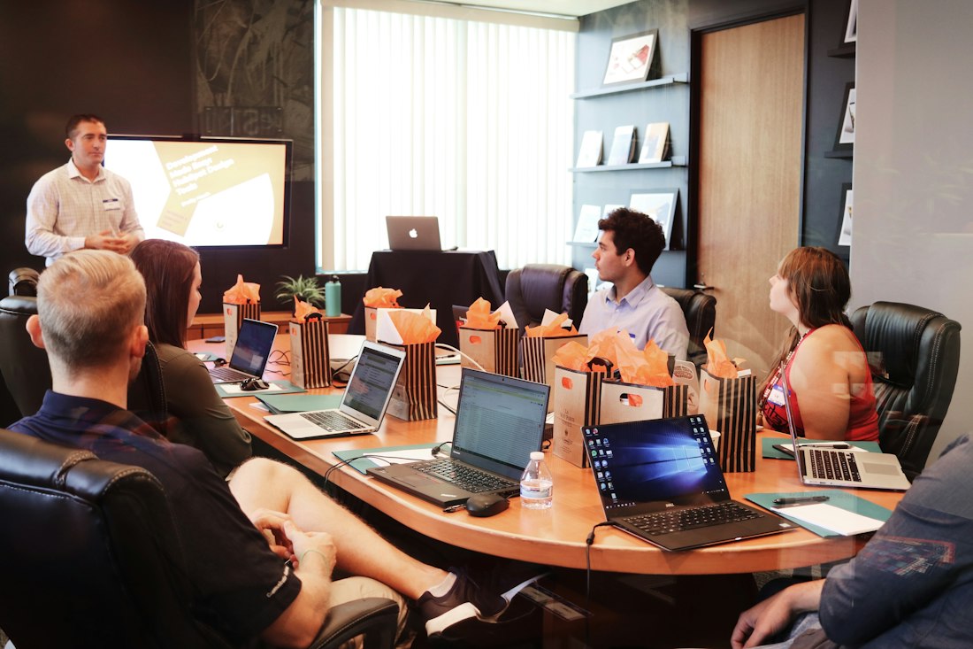 An agency team working around a table with laptops