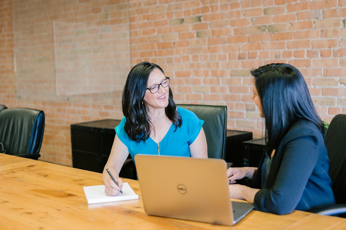 Two colleagues planning at a laptop