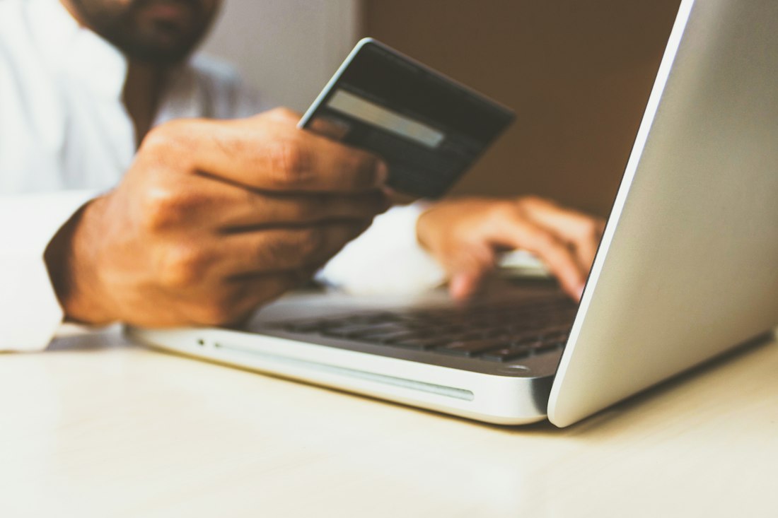 A customer entering card details at a laptop