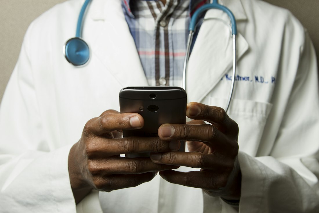 A doctor holding a phone